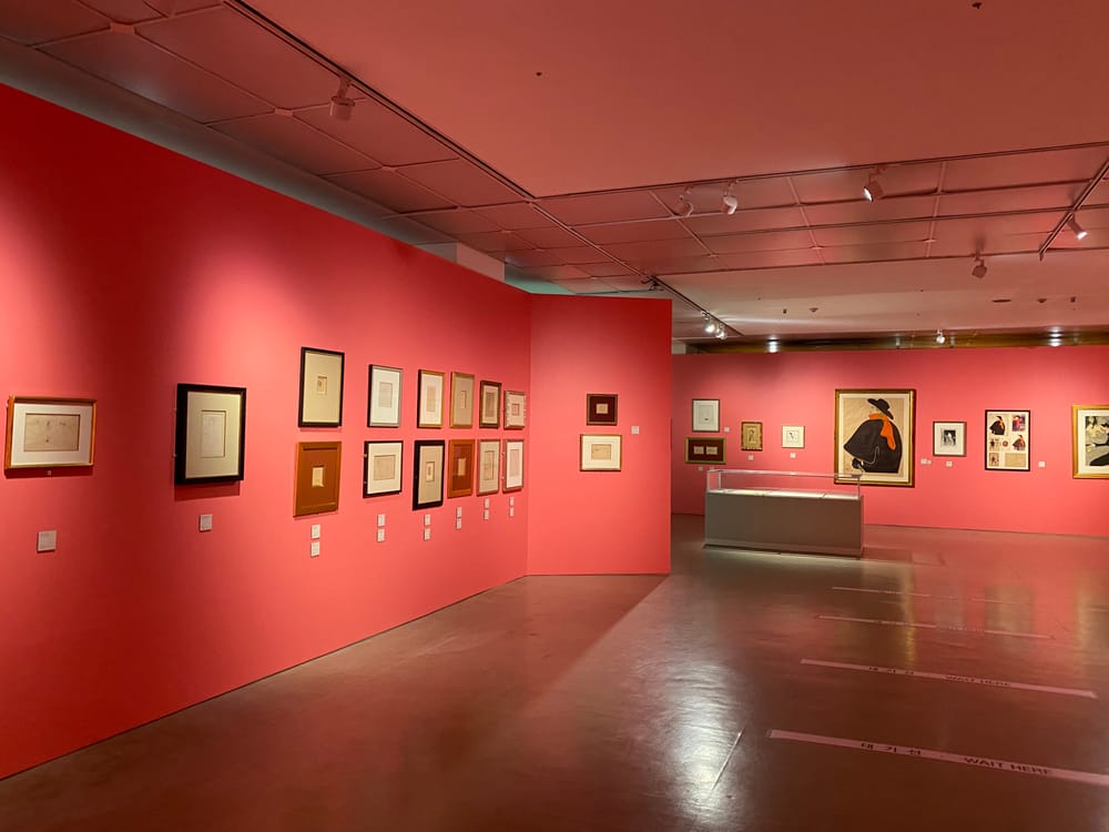 Red-walled gallery of Toulouse-Lautrec prints